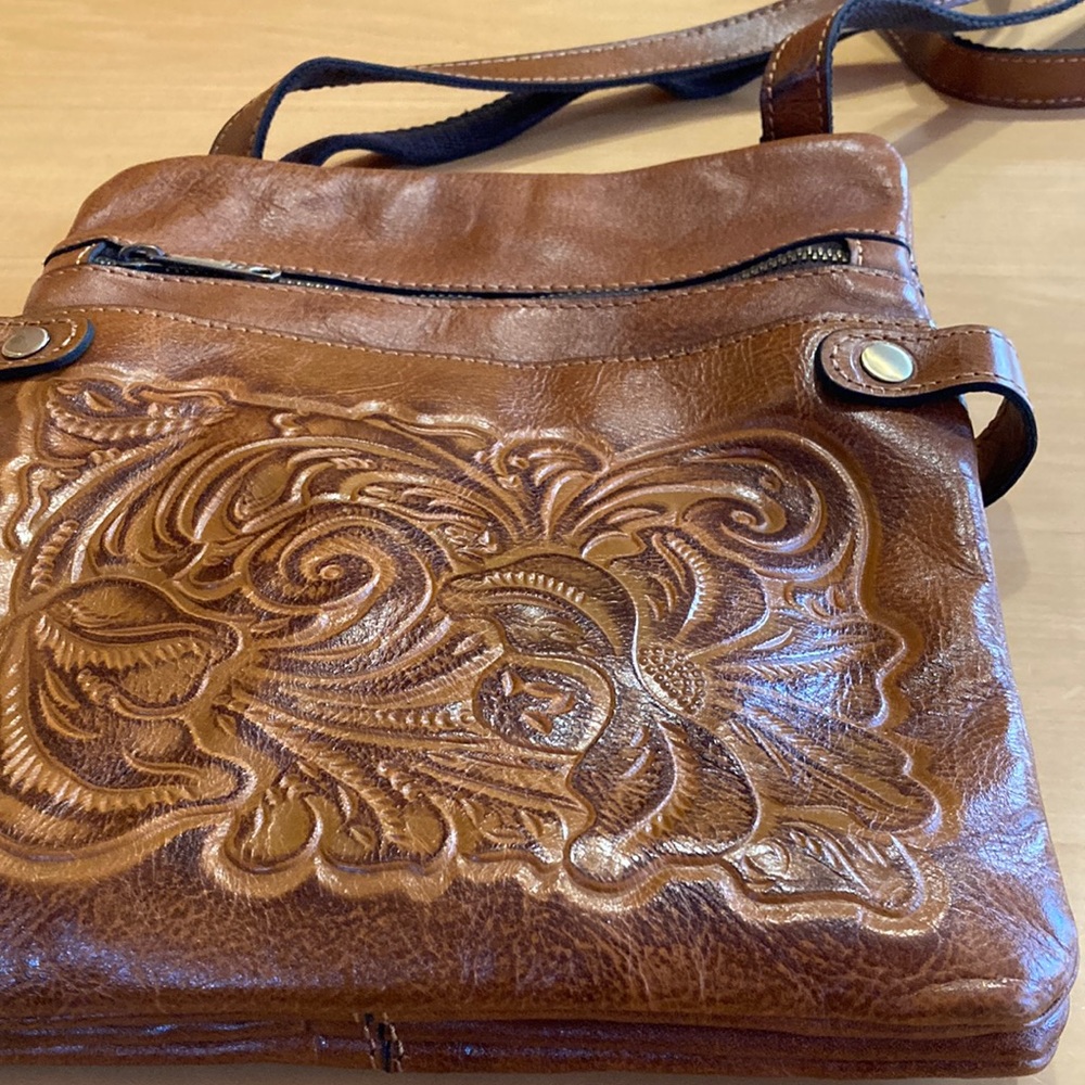 Ladies brand new large Patricia Nash crossbody bag with cloth bag.